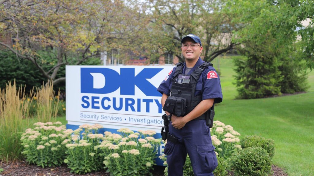 Armed security personnel standing in front of DK Security sign