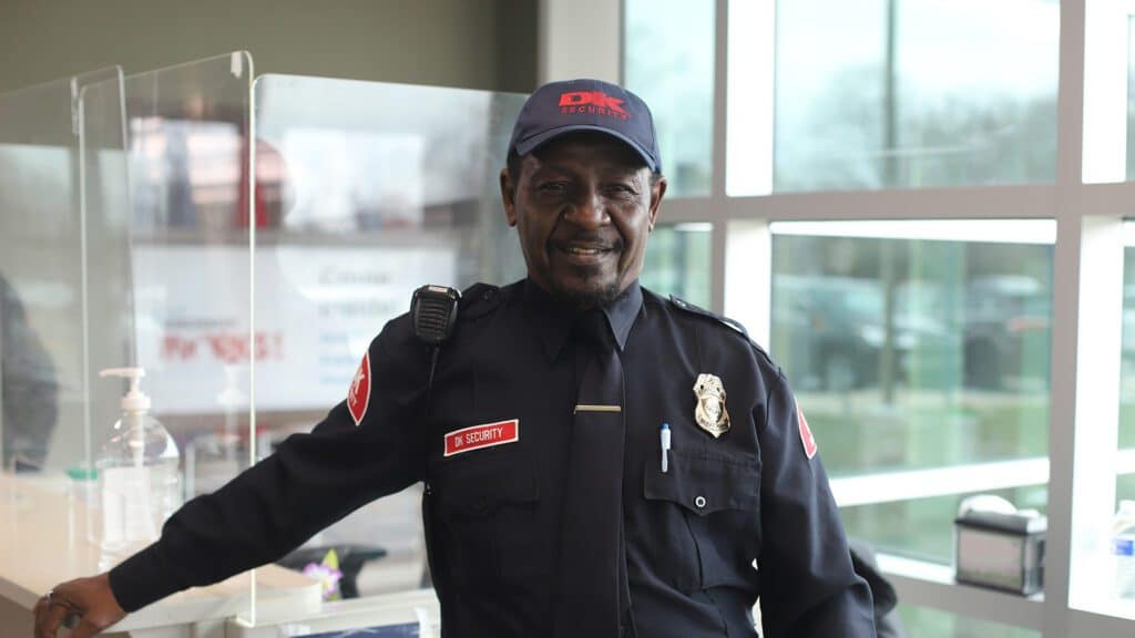 A public-facing DK Security guard tends to the reception desk of a Michigan healthcare facility.
