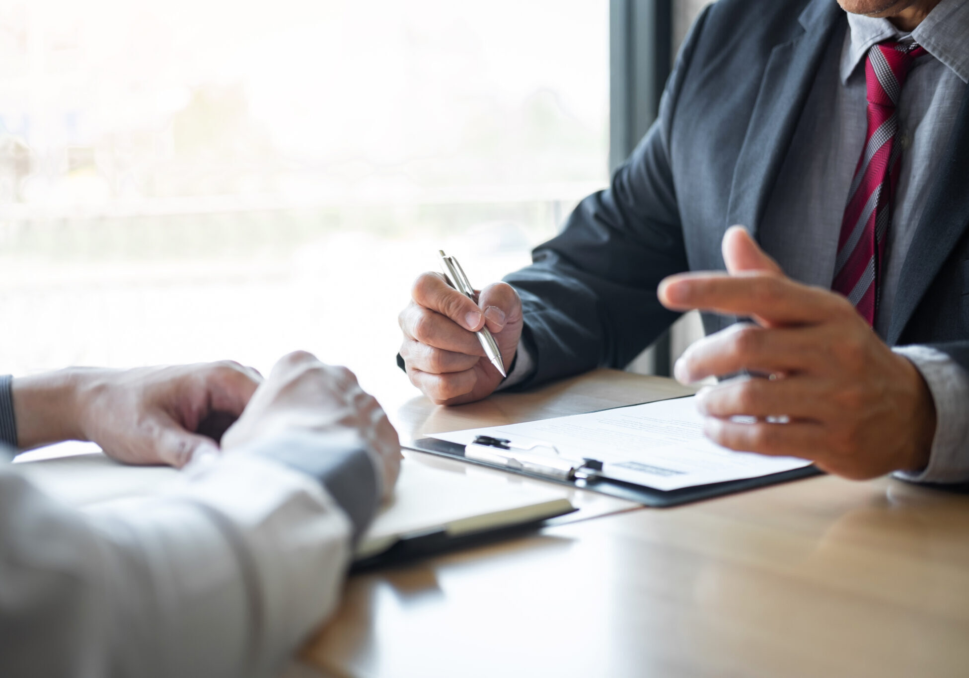 Employer or recruiter holding reading a resume during about colloquy his profile of candidate, employer in suit is conducting a job interview, manager resource employment and recruitment concept.