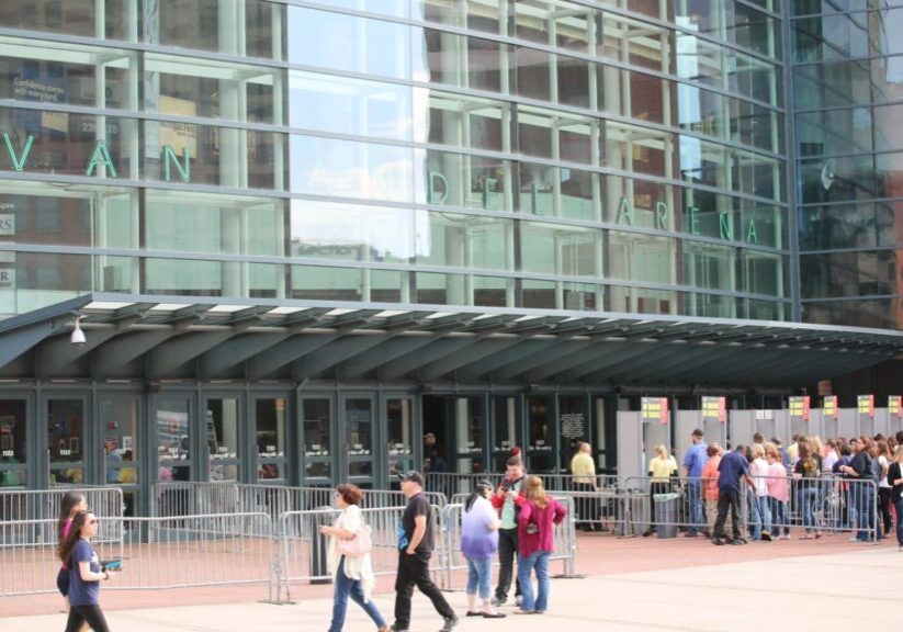 Security checking concert-goers outside of VanAndel Arena